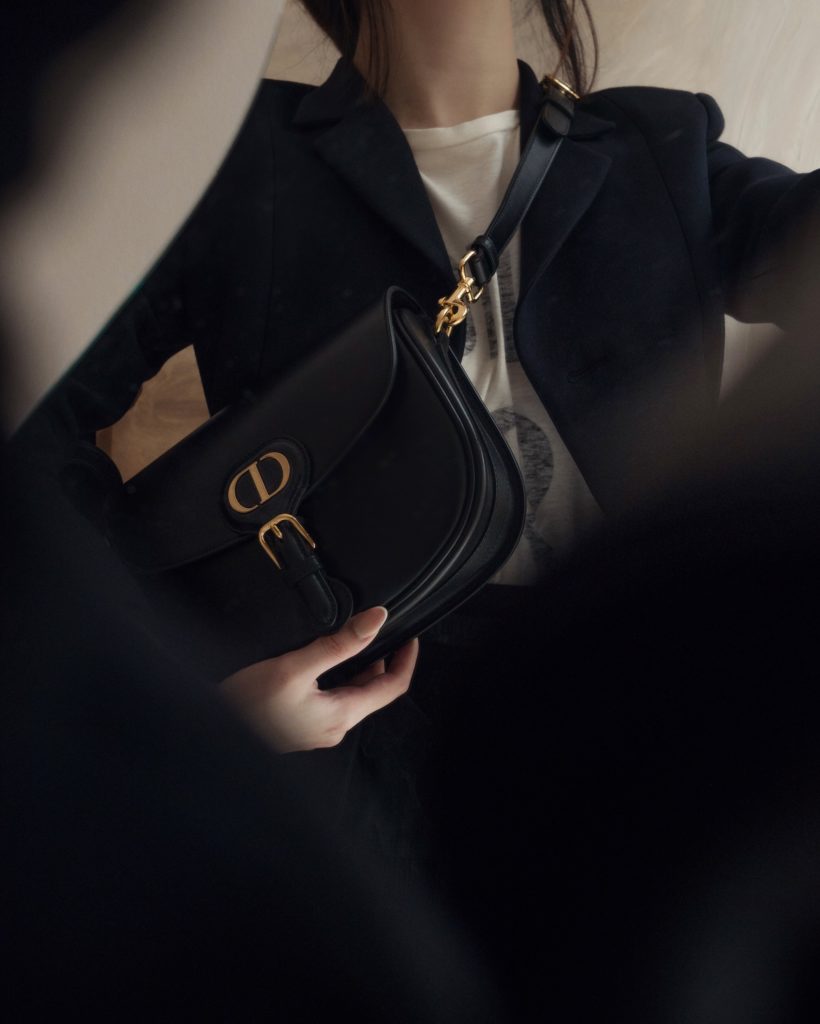 Dior's new classic and iconic bag, Dior Bobby in black calfskin, paired with Dior Bar Jacket. Photos By Willabelle Ong