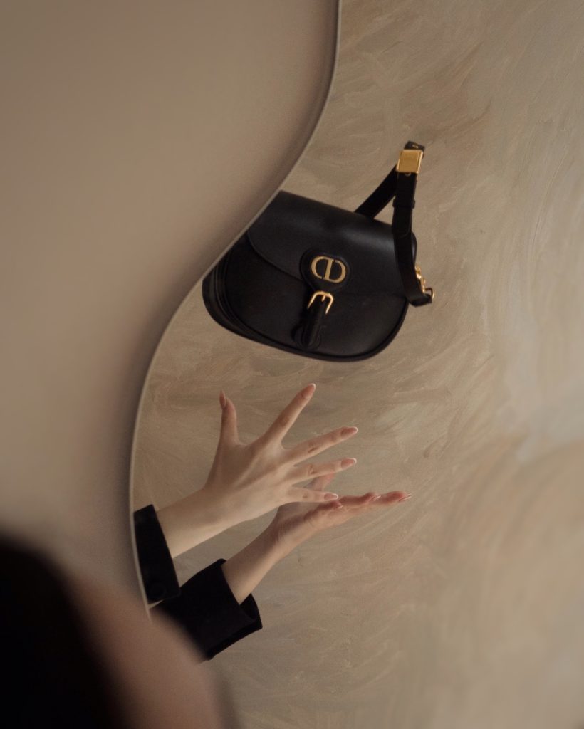 Dior's new classic and iconic bag, Dior Bobby in black calfskin, paired with Dior Bar Jacket. Photos By Willabelle Ong